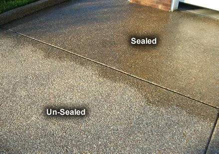 Exposed aggregate concrete with a sealed half that is darker than the unsealed half