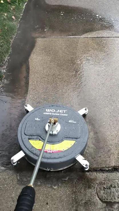 Surface cleaner on a concrete slab leaving a clean path